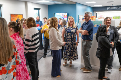 Employees and their families gather for the grand opening celebration