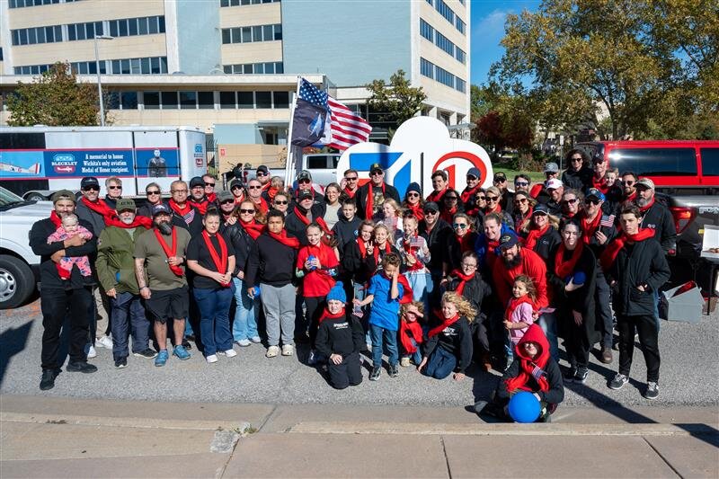 Members of the veteran-focused employee resource group VETCOM and their families prepare to walk in the Textron Aviation Veterans Day parade in downtown Wichita.