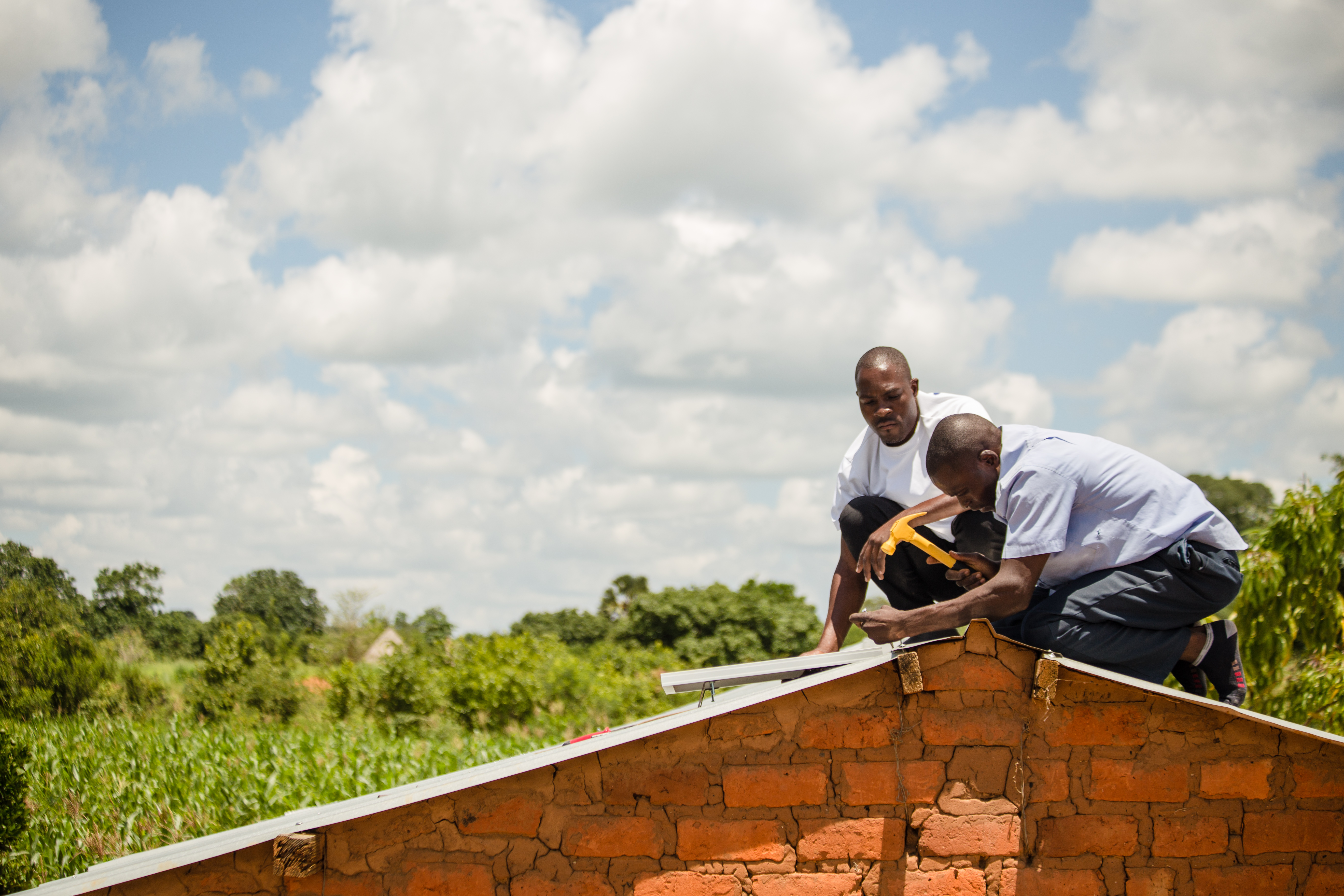 Image: Little Sun. Credit Chona Mwemba. Zambia_Sales agents installing a solar home system