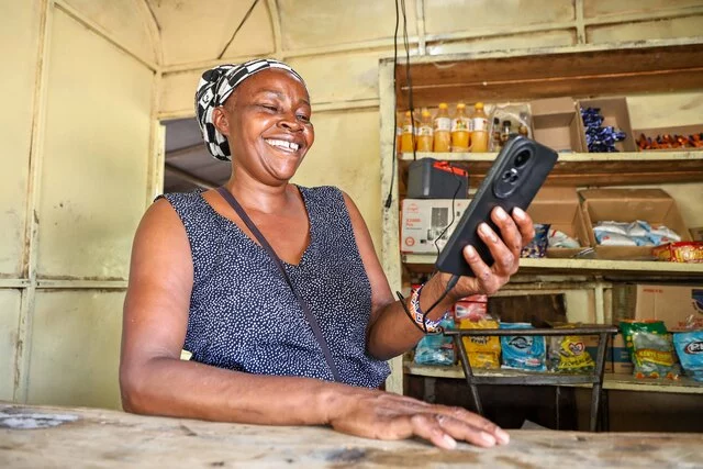 Off-grid solar system powering phone by dlight, GOGLA