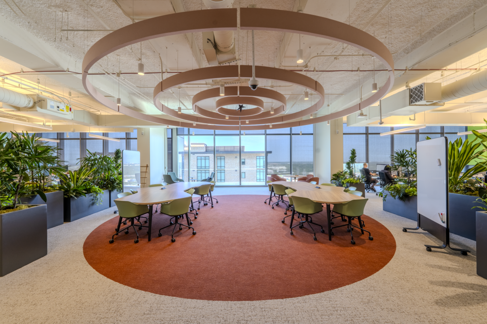 Breakout collaboration area featuring a concentric circle light fixture inspired by the State Capitol