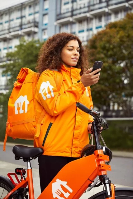 Courier_sRGB_ALL_2021_Courier1-0_Female-bike-phone-road_EXP-JUN2026