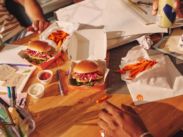 Lifestyle_sRGB_ALL_2025_Lunch_Working-Chicken-Burger-Sweet-Potato-Fries_Model-hands_EXP-AUG2030