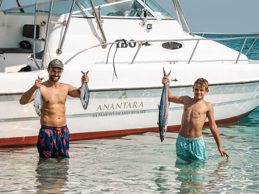 Anantara_Bazaruto_Island_Resort_Fishing_Boat_Father_and_Son_holding_catch_of_the_day.jpg