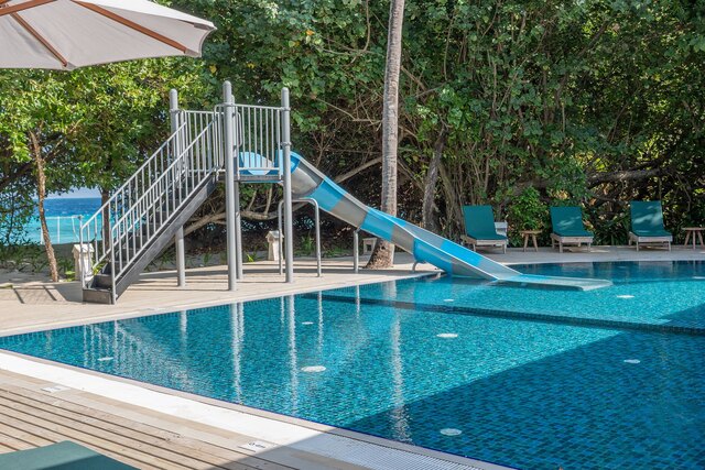 Family pool with water slide at NH Collection Maldives Reethi Resort.jpg