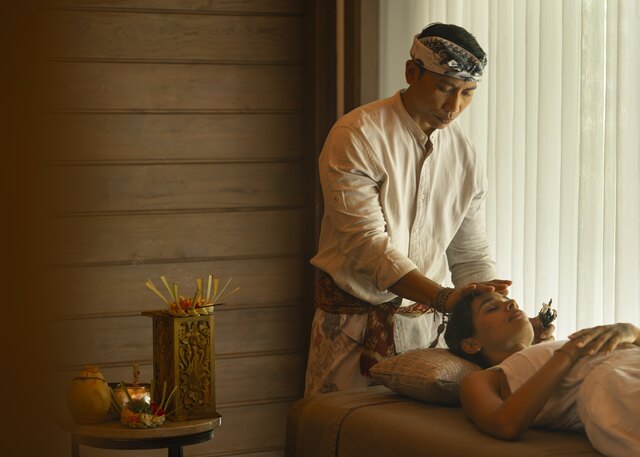 Made Wartana performing a healing ritual for a guest at Anantara Ubud Bali Resort.jpg