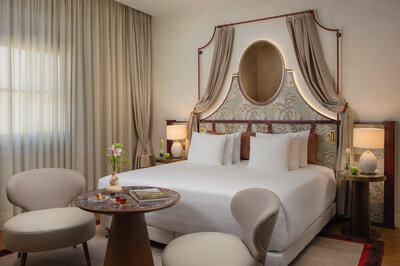 NH_Collection_Porta_Rossa_Room_Suite_526_Bed_Table_Chairs_Curtains_Closed