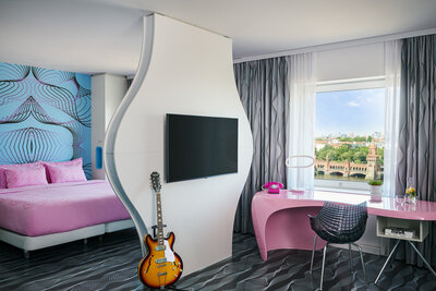 nhow_Berlin_Room_junior_suite_curtains_open_king_size_bed_guitar_tv_view