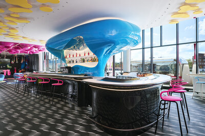 nhow_Berlin_Bar_blue_counter_pink_bar_stools_stage_view