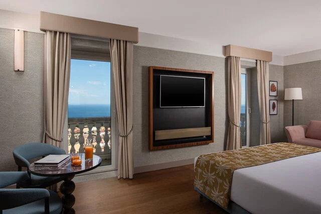 NH_Collection_Taormina_Room_Premium_View_Bed_Curtains_Open_Balcony
