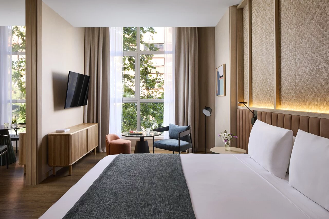 NH_Valencia_Center_Room_Suite_Window_Natural_Light_Tv.jpg
