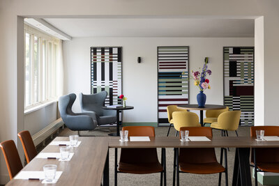 Avani_Museum_Quarter_Amsterdam_Hotel_Meeting_Rooms_Taeuber_Detail_View_Towards_Seating_Area_Colorful_Chairs_Artwork_Flowers