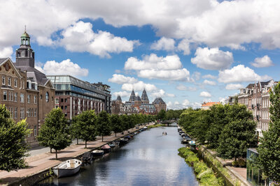 Avani_Museum_Quarter_Amsterdam_Hotel_Facade_Canal_Boat_Clouds_Summer_Green_Trees_Daytime