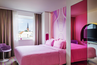 nhow_Berlin_Room_standard_curtains_open_king_size_bed_armchair_mirror_view