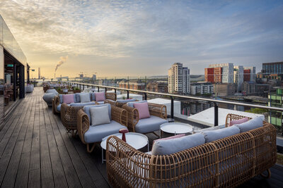 Anantara_The_Marker_Dublin_Rooftop_Bar_&_Terrace_General_Shoot_Daylights_Clouds_City_Views_Sofas_Pillows_Lamp_On_Table_Docklands