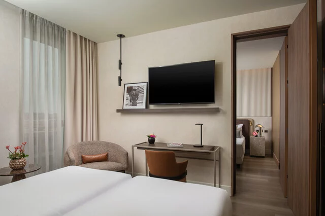 NH_Collection_Milano_CityLife_Room_Family_Interconnected_Bed_TV_Door_Sofa_Flowers_Table_Lamp