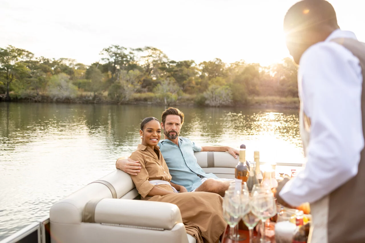 Anantara_Kafue_River_Tented_Camp_Couple_Boat_Sunset.jpg