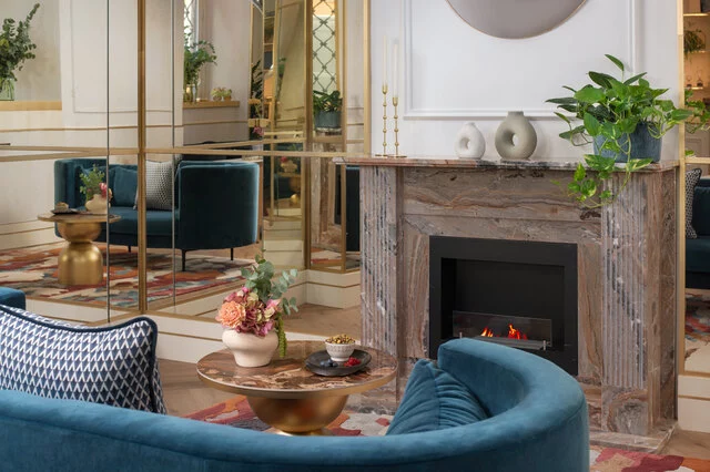 NH_Collection_Fori_Imperiali_Lobby_And_Reception_Fireplace_Area_Couch_Flowers