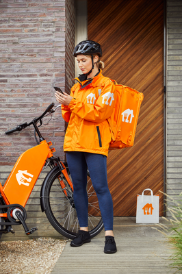 Courier_sRGB_ALL_2021_Courier1-0_Female-Dropping-off-food-at-house_EXP-JUN2026