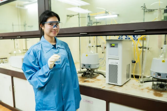 Proud holding a sample of upcycled unsaturated polyester resin during material development in the lab