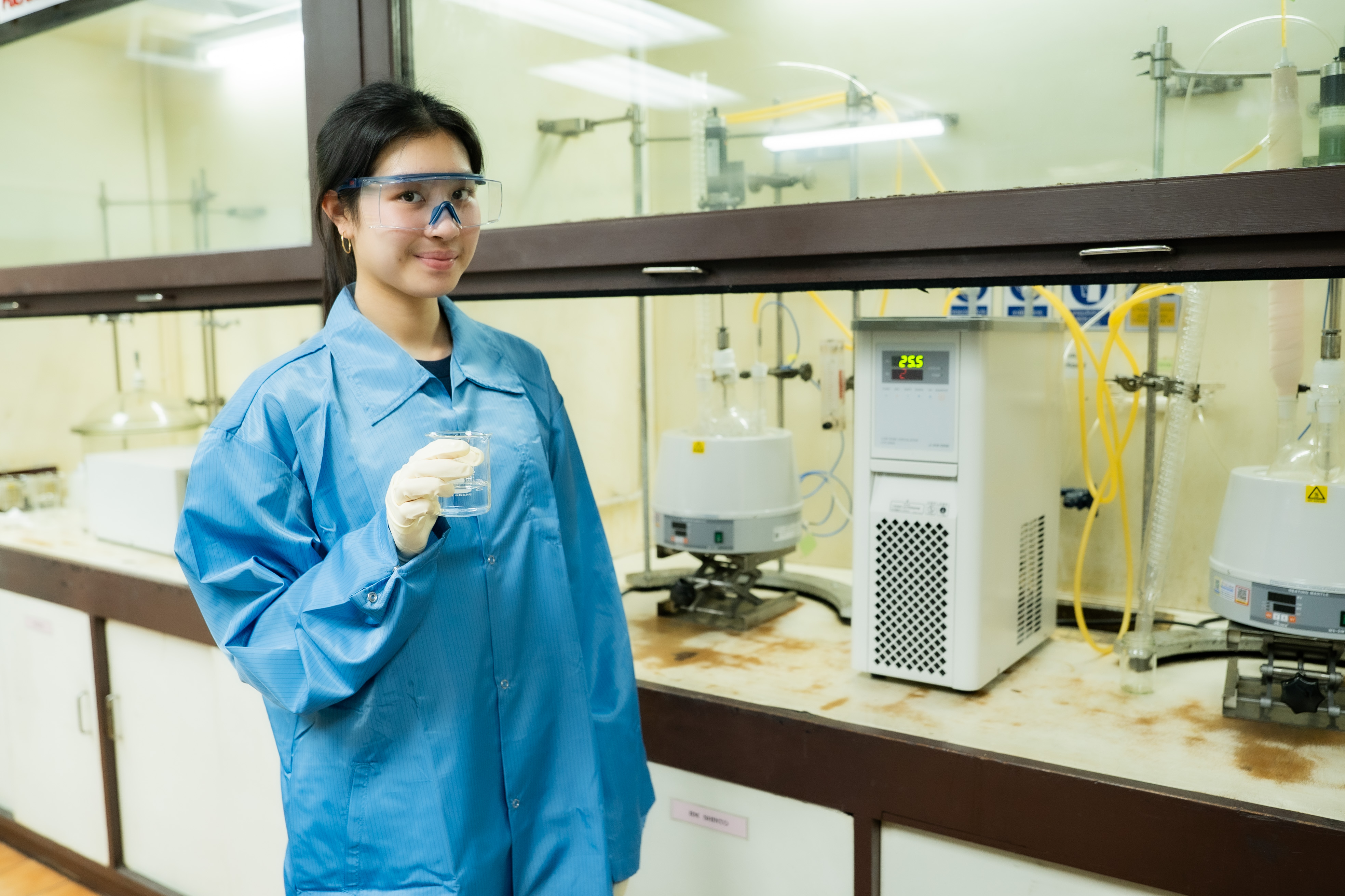 Proud holding a sample of upcycled unsaturated polyester resin during material development in the lab