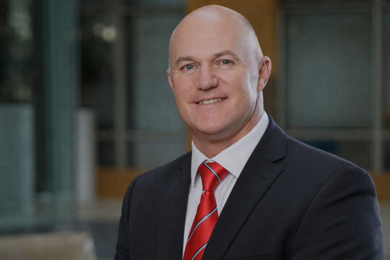 Professional portrait with a red tie.png